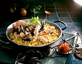 Paella with mussels, shrimp and parsley in wok