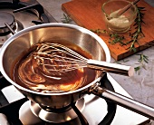Sauce with whisk in sauce pan