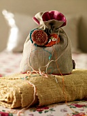 Close-up of small linen bag with crochet flowers