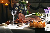 Roasted wild boar with pears and stuffed cabbage on dining table