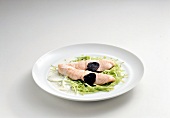 Slices of salmon with truffles on salad bed