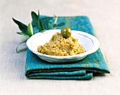 Green olive tapenade on plate
