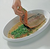 Fish fillets with seasoning in between in serving dish, step 4