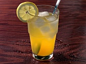 Tropical wine cooler drink with lemon slice on rim