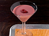 Saintly bell cocktail in glass on tray