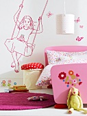 Children room with pink bed and girl on swing motif on wall
