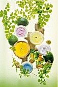 Herbs, lemon, citrus fruits, ginger and cream boxes against green background