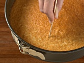 Close-up of baked cake being poked with toothpick, step 3