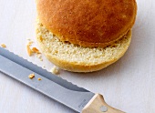 Giant burger bread halved with knife