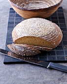 Sliced millet bread on chopping board