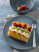 Piece of colourful fruit cake on plate
