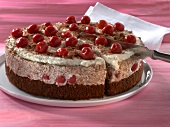 Cherrie cake being cut with spatula on plate