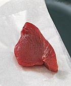 Fillet of raw meat on white baking paper