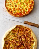 Carrot, potato quiches and leek tart cheese quiche on white surface