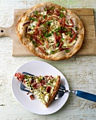 Slice of quiche on plate with ham and turnip quiche on cutting board