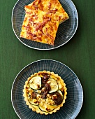 Salami corners and lamb zucchini tart on plates