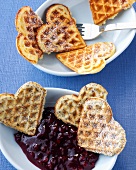 Lemon curd waffles and poppy seed waffles in serving dishes
