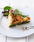 Piece of vegetable quiche on plate