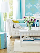 White sofa with button padding, turquoise curtains and floor lamp in living room