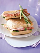 Panini with ham, capers and rosemary on plate