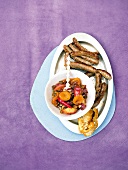 Lamb sausages with apricot chutney and white bread slice on plate