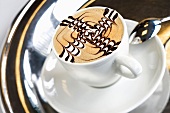 Coffee foam decorated with chocolate in shape of swirls