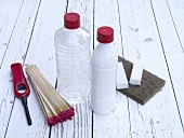 Lighter and fuel assistance for barbecue on wooden background