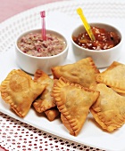 Close-up of dips with snacks