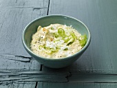 Bowl of eggs and onion cream on wooden background