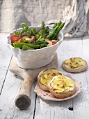 Green asparagus salad and potato pizzas in bowl