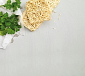Stir fried instant noodles and mie noodles with coriander on white background, copy space