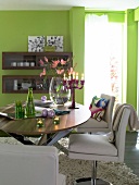 Table with green glasses, dishes and candlesticks