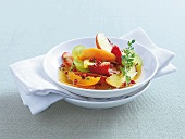 Pepper fruits with thyme, grapes, apricots and peaches in serving dish