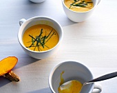 Thai pumpkin soup with basil in cups
