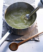 Masala spinach cream being blend in pot