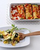 Baked cannelloni and farfalle ricotta tart in serving dishes 