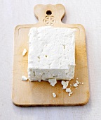 Cheese on wooden chopping board