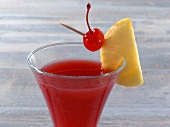 Pussy Foot drink in glass with pineapple and cherry on rim