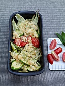 Spring vegetables with wild garlic crumble, tomatoes and zucchini in serving bowl