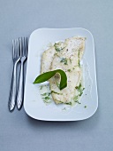 Plaice fillet with wild garlic sauce on plate