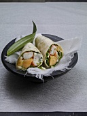 Shrimp wraps with wild garlic mayo and cloth in bowl