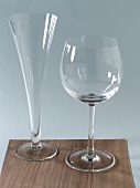 Champagne flute and wine glass on wooden board