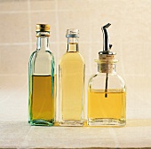 Glass bottles of olive oil, sunflower oil and rapeseed oil