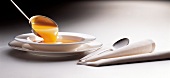 Pumpkin soup being poured with ladle in bowl