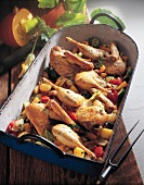 Duck pieces with vegetables in roasting dish