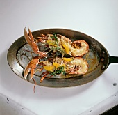 Fried lobster with fennel and orange in pan