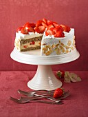 Strawberry cake with flaked almonds on a cake stand