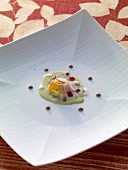 Fried egg with liquid herb salad, smoked cheese and carpaccio on square plate