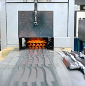 Blade hardened in furnace during blade production, Swabia, Germany
