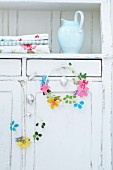 Easter wreaths of wire and felt flowers on door of old cupboard